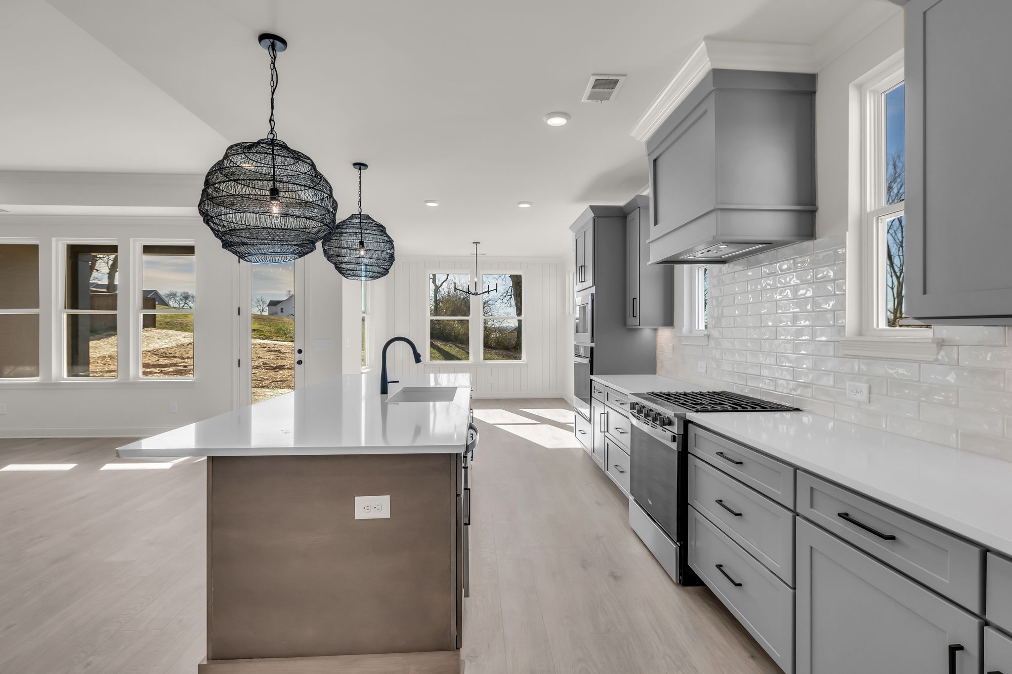 207 Phillips Bend Spring Hill, TN 37174 - Photo 11 of 55 a kitchen with stainless steel appliances granite countertop a stove a sink and a wooden floors