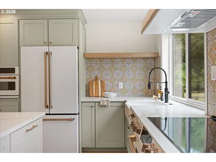 a kitchen with a refrigerator and a sink