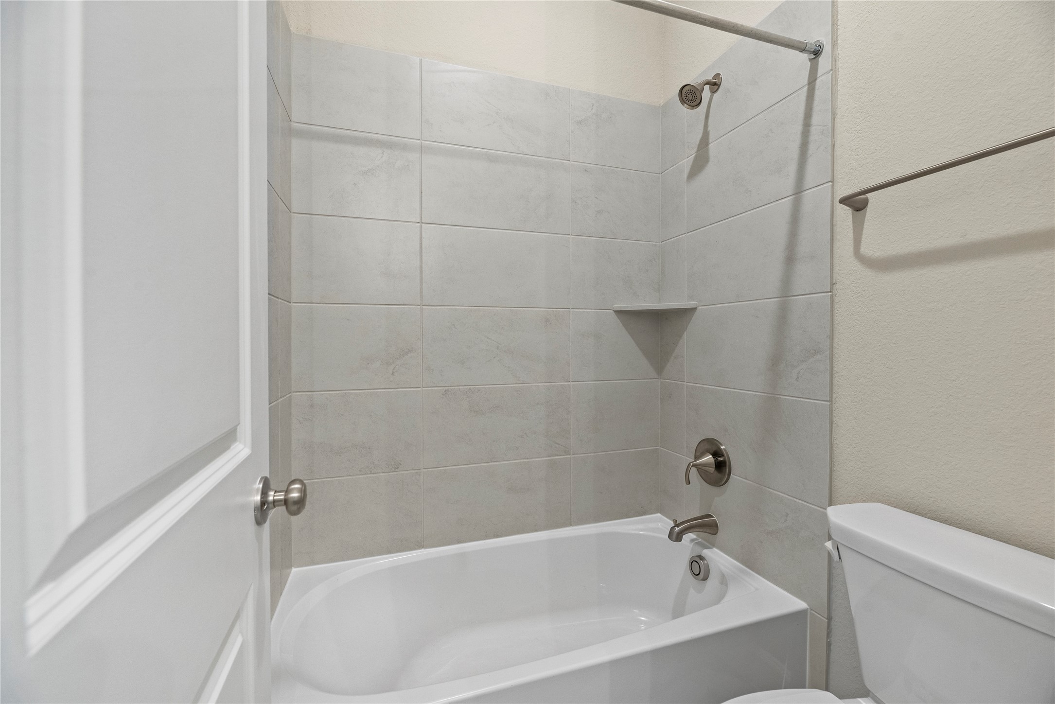 3111 Swift Way Katy, TX 77493 - Photo 19 of 50 a bathroom with a bathtub and a toilet