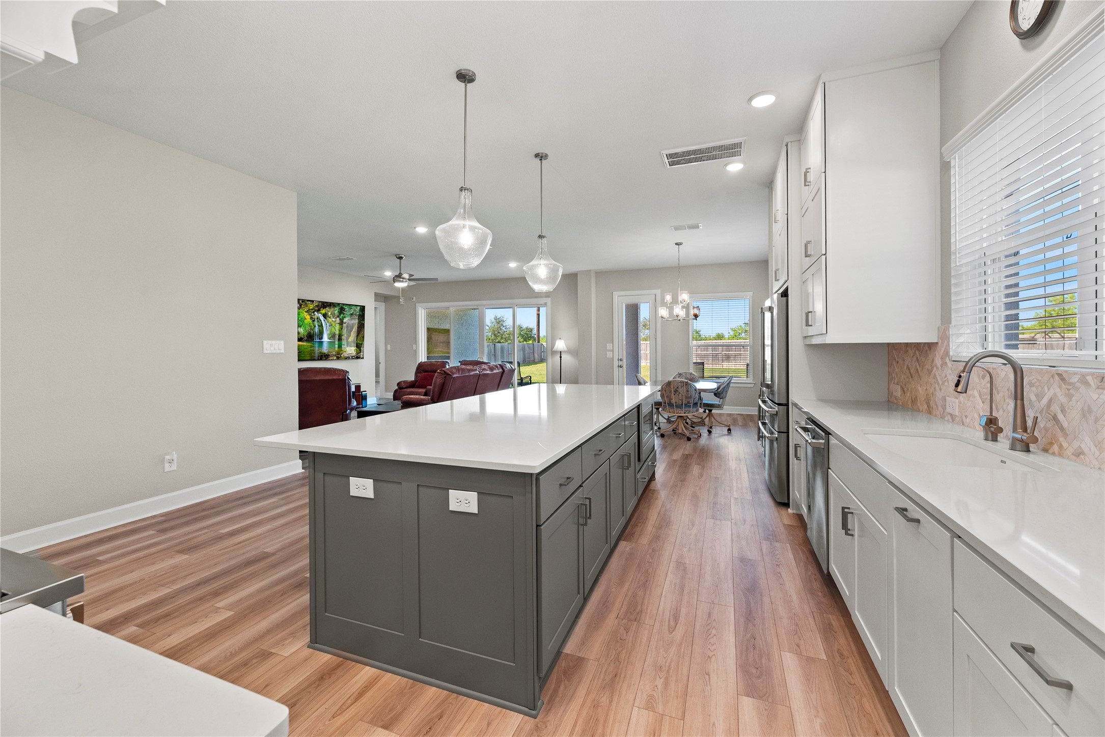 3111 Swift Way Katy, TX 77493 - Photo 30 of 50 a kitchen with kitchen island a sink stove and wooden floor
