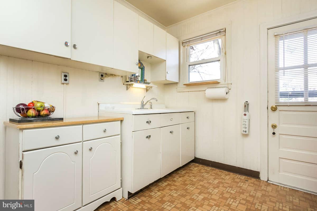 4604 Schenley Road Baltimore, MD 21210 - Photo 11 of 30 a kitchen with white cabinets and sink