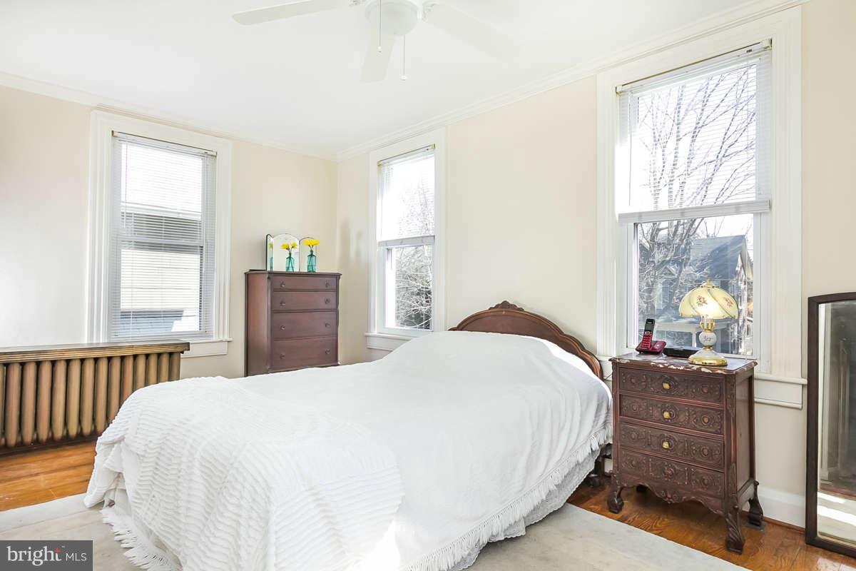 4604 Schenley Road Baltimore, MD 21210 - Photo 14 of 30 a bedroom with a bed and wooden floor