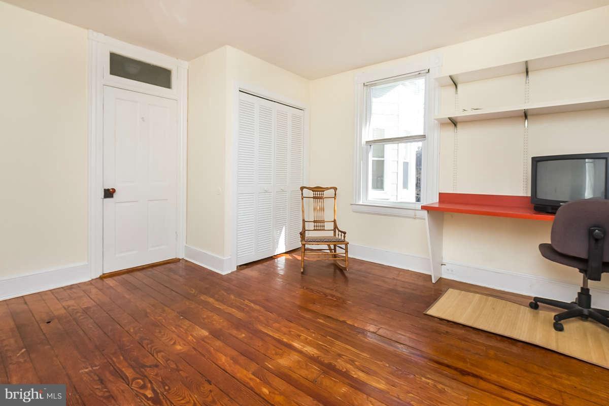 4604 Schenley Road Baltimore, MD 21210 - Photo 15 of 30 a view of an empty room with a window and wooden floor