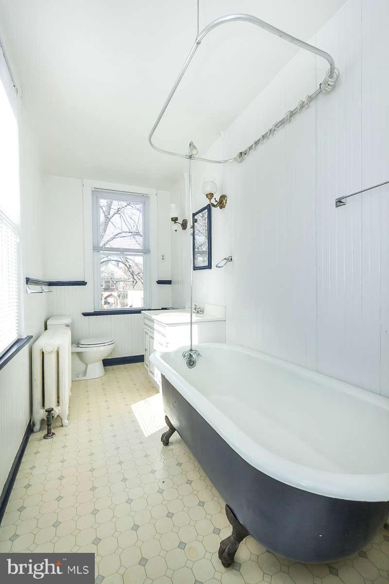 4604 Schenley Road Baltimore, MD 21210 - Photo 16 of 30 a bathroom with a tub sink and mirror