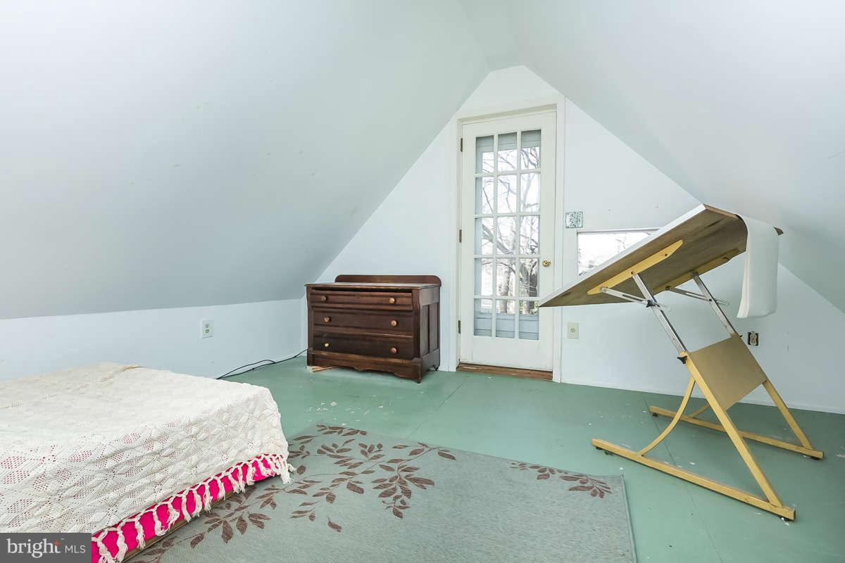 4604 Schenley Road Baltimore, MD 21210 - Photo 23 of 30 a bedroom with a bed and a bookshelf