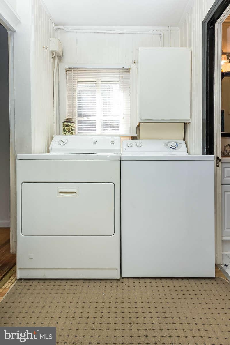 4604 Schenley Road Baltimore, MD 21210 - Photo 24 of 30 a bathroom with a sink a mirror and a window