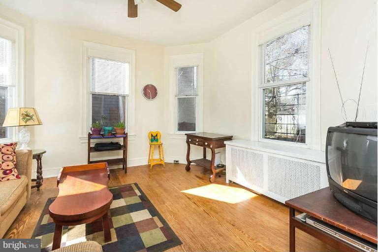 4604 Schenley Road Baltimore, MD 21210 - Photo 4 of 30 a living room with furniture a flat screen tv and a window