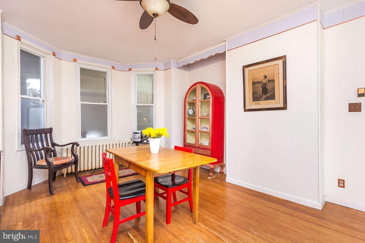 4604 Schenley Road Baltimore, MD 21210 - Photo 7 of 30 a view of a dining room with furniture and wooden floor
