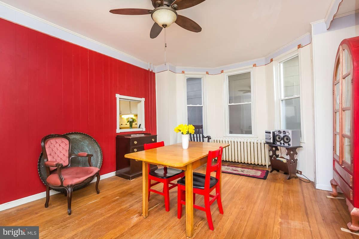 4604 Schenley Road Baltimore, MD 21210 - Photo 8 of 30 a view of a dining room with furniture window and wooden floor