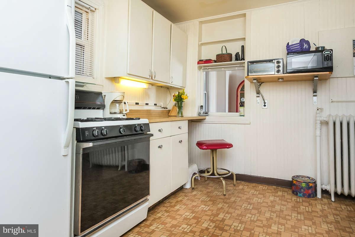 4604 Schenley Road Baltimore, MD 21210 - Photo 10 of 30 a kitchen with stainless steel appliances granite countertop a stove and a refrigerator