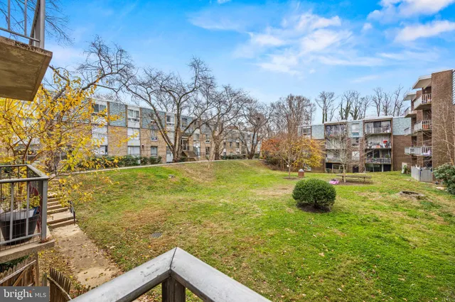 a view of a balcony with yard