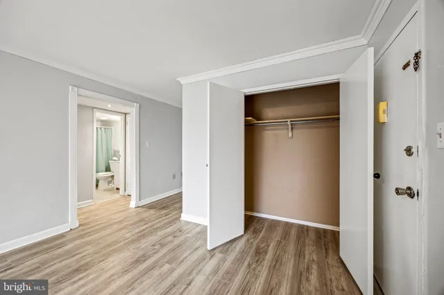 a kitchen with stainless steel appliances granite countertop a refrigerator a sink dishwasher a stove and white countertops with wooden floor