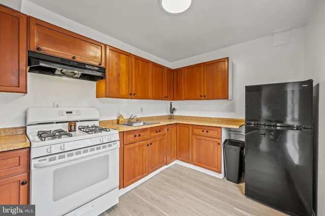 a kitchen with stainless steel appliances a stove and a refrigerator