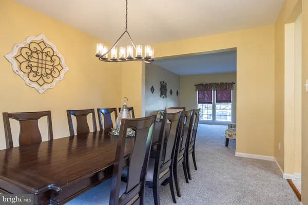 a view of a dining room with furniture and chandelier