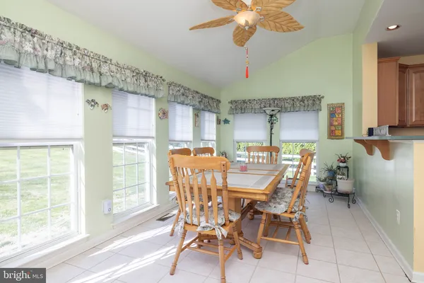 a dining room with furniture and window