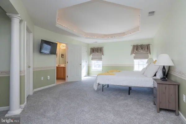 a bedroom with furniture and a flat screen tv