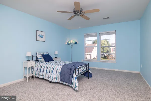 a bedroom with a bed dresser and a window
