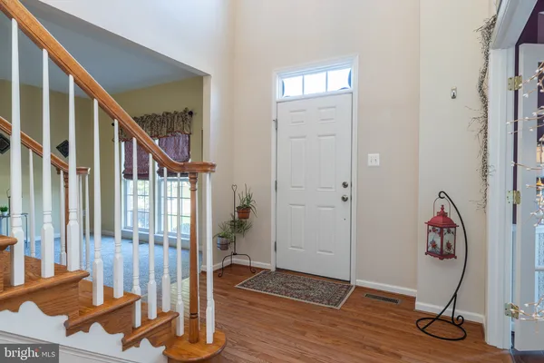 a view of an entryway with wooden floor and door