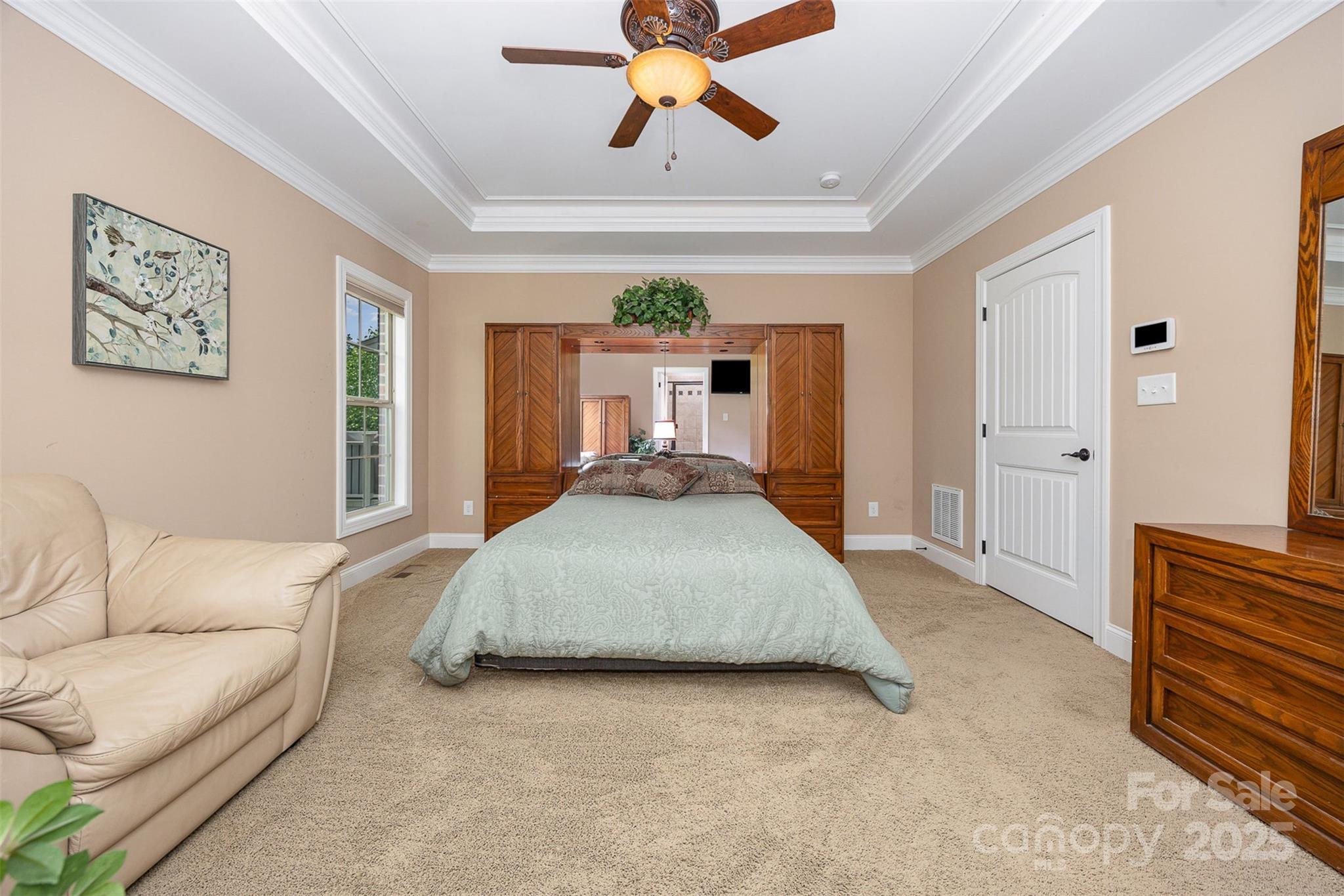 375 Pebblestone Court Lexington, NC 27295 - Photo 16 of 34 a spacious bedroom with a bed couch chandelier and a window