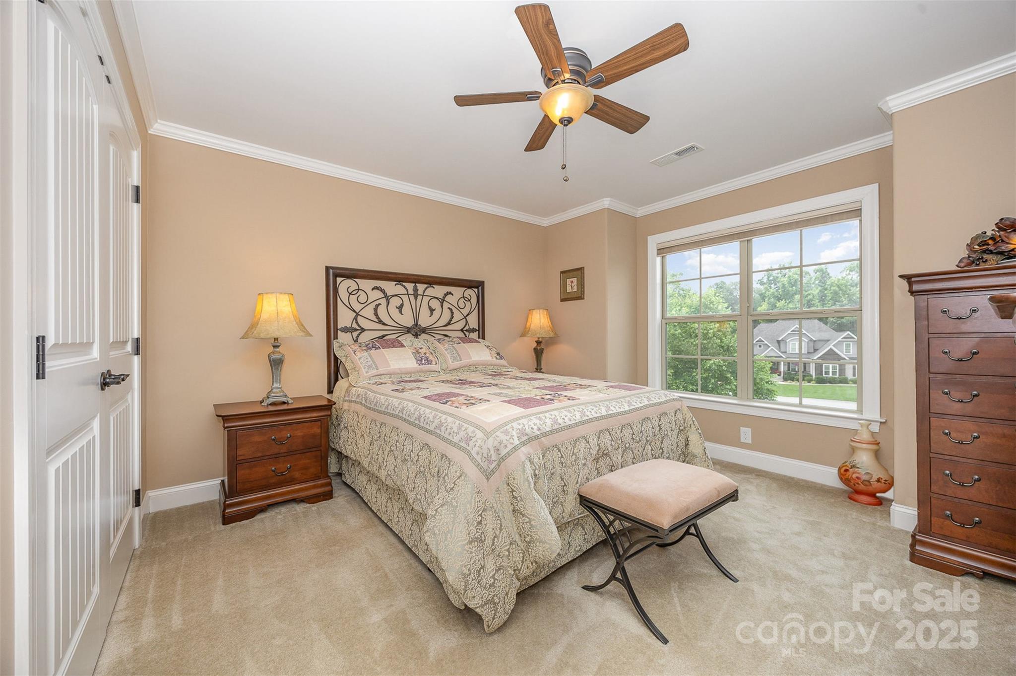 375 Pebblestone Court Lexington, NC 27295 - Photo 24 of 34 a bedroom with a bed and a chandelier