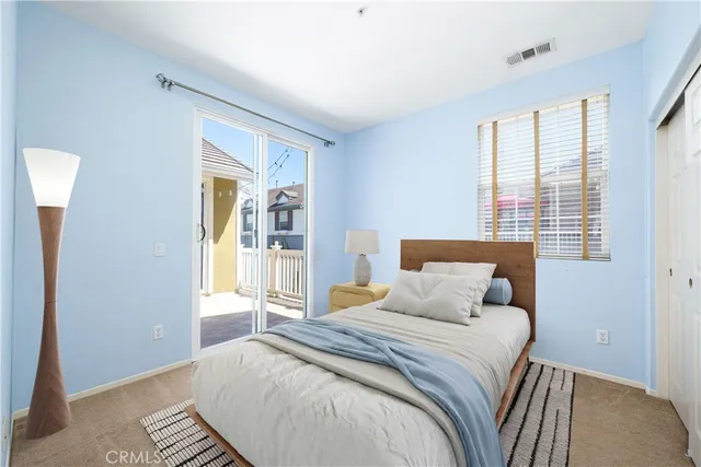 a bedroom with a large bed and a window