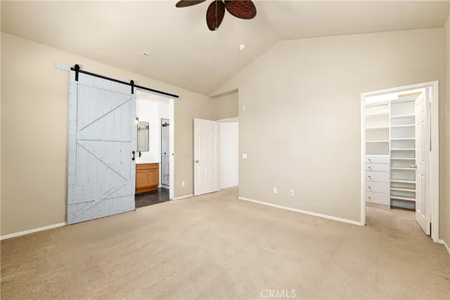 a view of empty room with ceiling fan