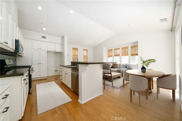 a kitchen with a refrigerator and a stove top oven