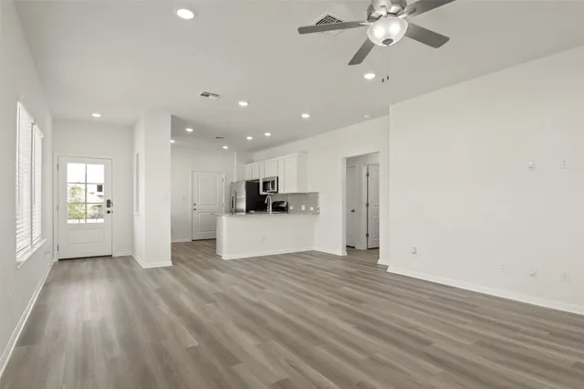 a view of a kitchen with a sink and a refrigerator