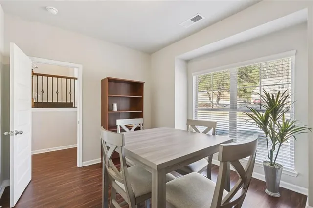 a view of a dining room with furniture window and wooden floor