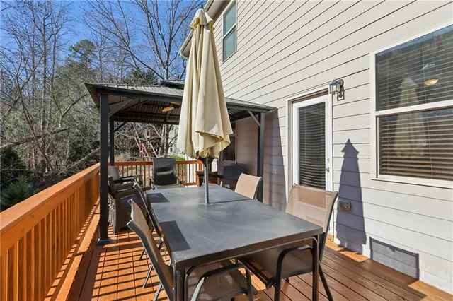 a view of deck with furniture and garden