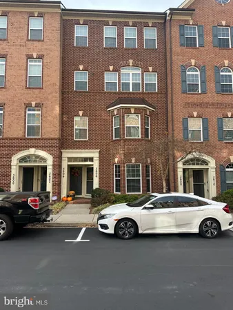 a buildings with car parked in front of it