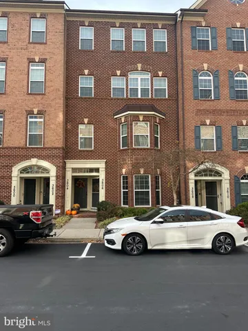 a buildings with car parked in front of it