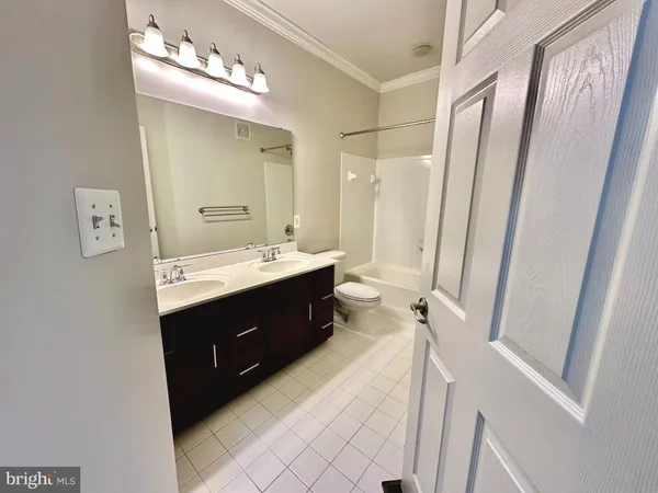 a bathroom with a sink double vanity and a mirror