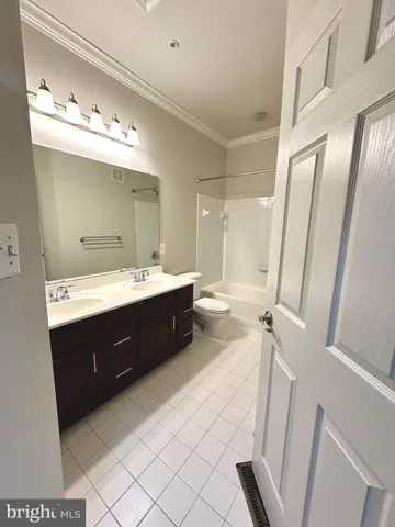 a spacious bathroom with a double vanity sink a mirror and a bathtub
