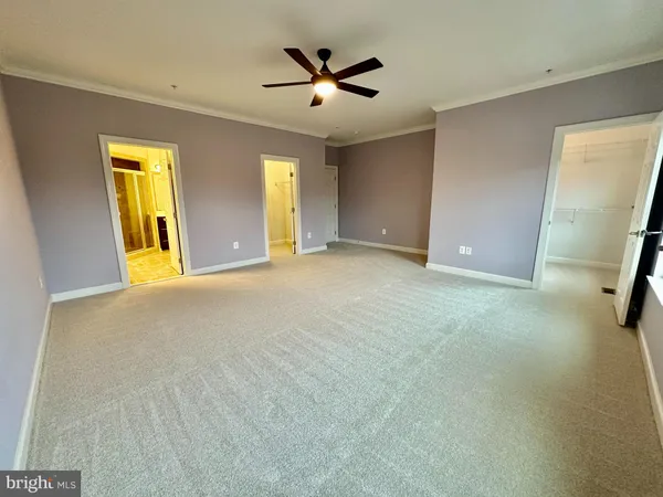 a view of a livingroom with a ceiling fan and window