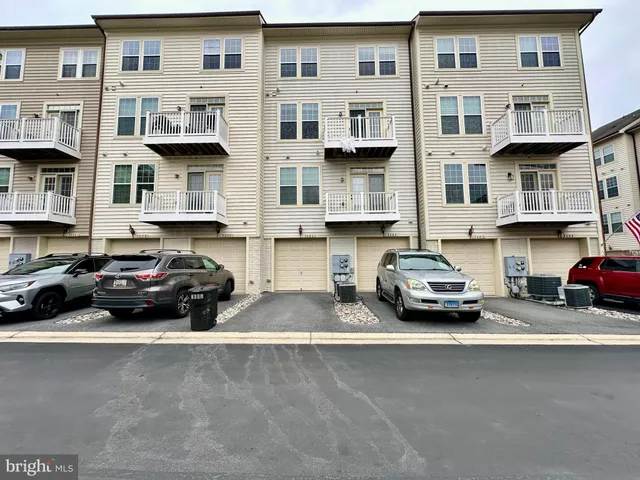 a car parked in front of a big white building
