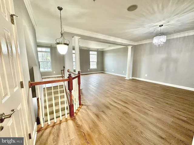 a view of a room with wooden floor and staircase