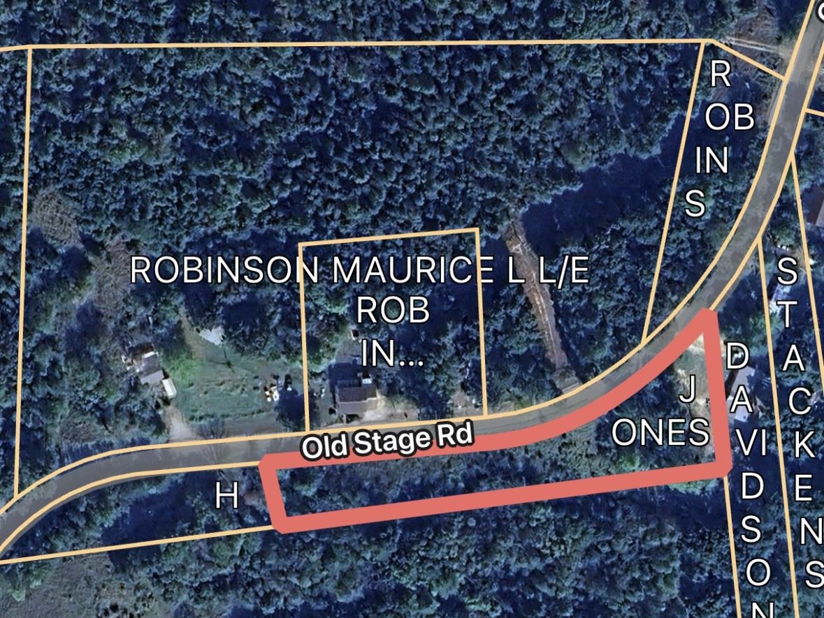 8069 Old Stage Road Adamsville, TN 38310 - Photo 33 of 34 a street sign on a wall next to a road