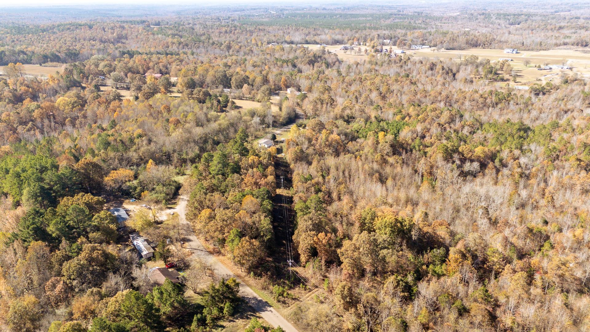 8069 Old Stage Road Adamsville, TN 38310 - Photo 8 of 34 an aerial view of residential houses with city and green space