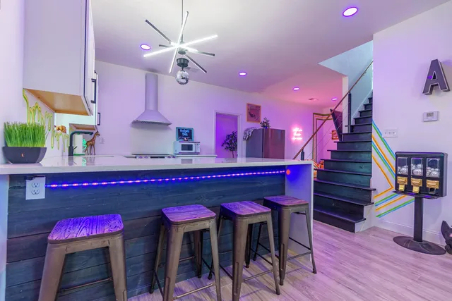 an outdoor sitting area with couch and wooden fence