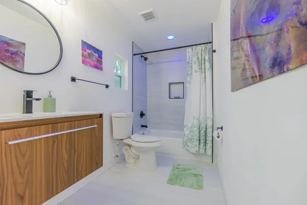 a bathroom with a toilet a sink and a shower