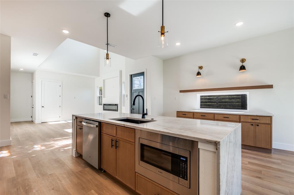 2424 Jeffries Street Dallas, TX 75215 - Photo 15 of 28 Kitchen featuring stainless steel appliances, light stone counters, light wood-type flooring, and recessed lighting