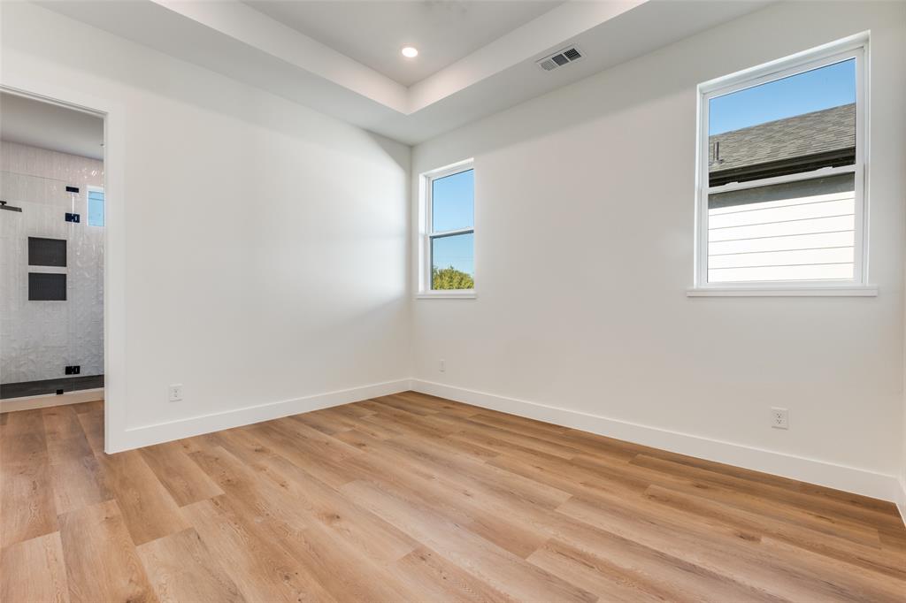 2424 Jeffries Street Dallas, TX 75215 - Photo 22 of 28 Spare room featuring healthy amount of natural light, light wood-style flooring, and recessed lighting