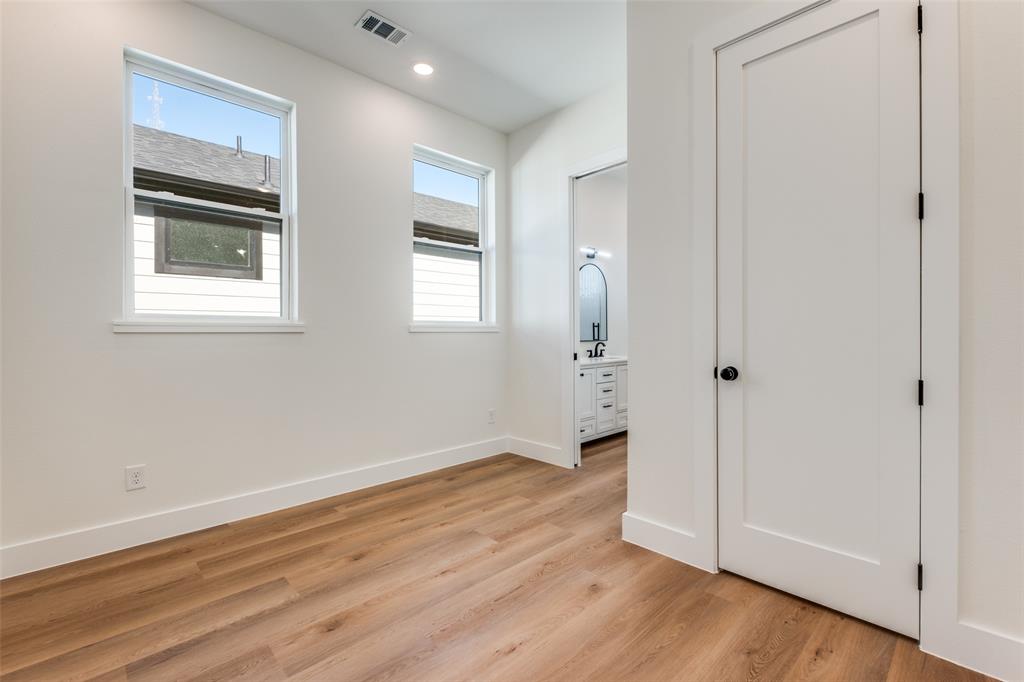 2424 Jeffries Street Dallas, TX 75215 - Photo 23 of 28 Unfurnished bedroom featuring connected bathroom, light wood-type flooring, and recessed lighting