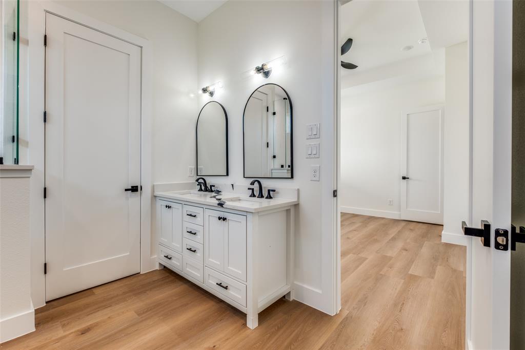 2424 Jeffries Street Dallas, TX 75215 - Photo 25 of 28 Full bathroom with light wood-style flooring, double vanity, and ceiling fan