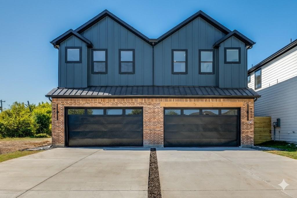 2424 Jeffries Street Dallas, TX 75215 - Photo 28 of 28 Modern farmhouse featuring a standing seam roof, a metal roof, an attached garage, and brick siding