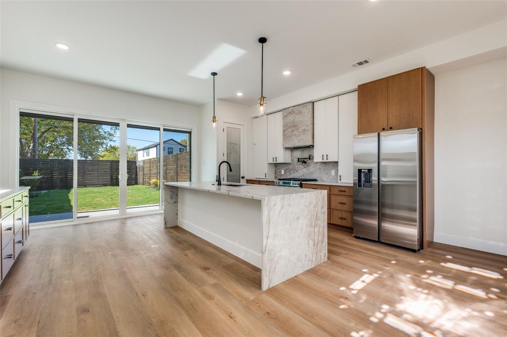 2424 Jeffries Street Dallas, TX 75215 - Photo 8 of 28 Kitchen with white cabinetry, stainless steel appliances, decorative light fixtures, recessed lighting, and backsplash