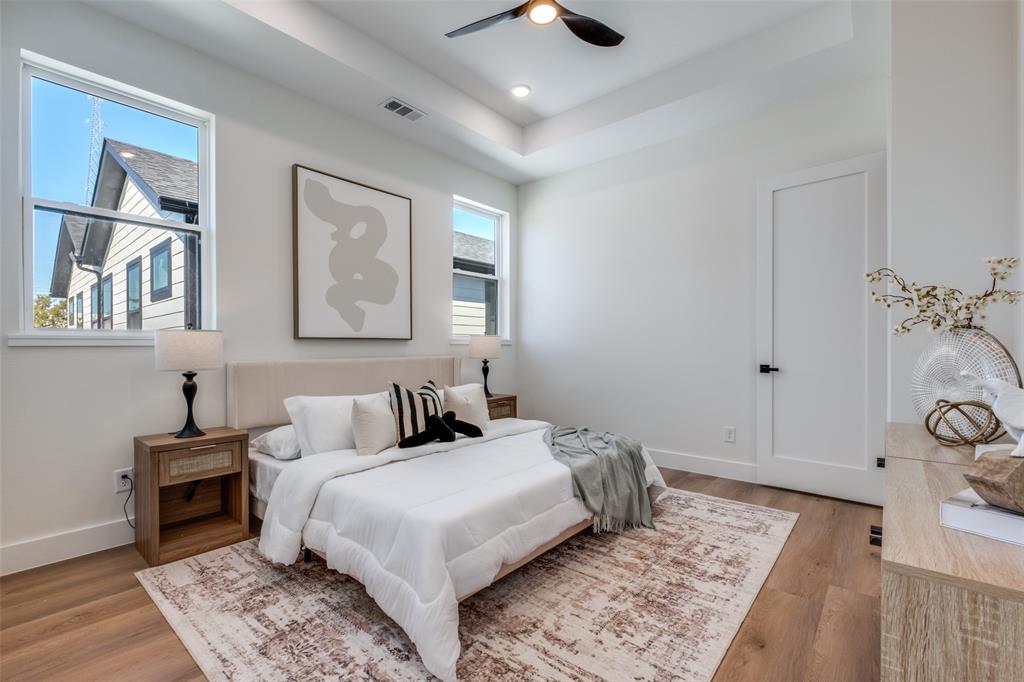 2424 Jeffries Street Dallas, TX 75215 - Photo 10 of 28 Bedroom with light wood finished floors, a raised ceiling, and a ceiling fan
