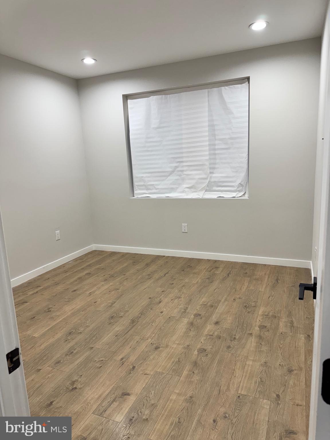 2256 North 9th Street, Unit 1 Philadelphia, PA 19133 - Photo 14 of 29 an empty room with wooden floor and windows