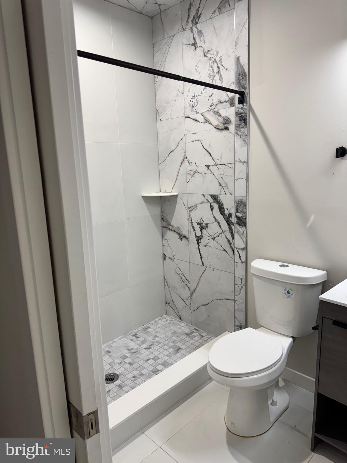 2256 North 9th Street, Unit 1 Philadelphia, PA 19133 - Photo 28 of 29 a white toilet sitting next to a shower curtain